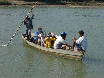 The group poled across a river by boat — no bridge here