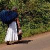 A Purepecha woman walks down the road after a trip to the market