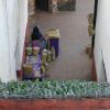An old woman sells her straw skeletons and other figures in La Casa de los Once Patios (house of the eleven courtyards), originally (1740) a Dominican