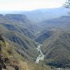 A river carves its home in between the mountains.