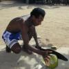 Luis P�rez Ventura cuts open a fresh coconut for a breakfast drink.