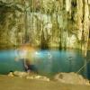 Cenote Xkeken. At around midday the sun comes through a hole in the ceiling penetrating deep into the cenote and in turn illuminating the cave in a ma