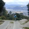 Ursula cycles up 2750 metre high Huitepec mountain with San Crist&oacute;bal in view behind.