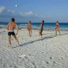 Playing volleyball on the beach in Tulum.